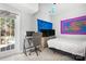 Bright bedroom featuring a desk area, TV, and walkout access to the backyard pool at 105 Easy St, Mooresville, NC 28117