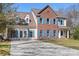 Charming two-story brick home featuring blue shutters, a well-manicured lawn, and a spacious driveway at 105 Easy St, Mooresville, NC 28117