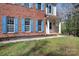 Close up of a two-story home featuring brick and siding exterior, blue shutters, and a covered porch at 105 Easy St, Mooresville, NC 28117