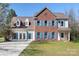 Charming two-story home featuring brick and siding exterior, blue shutters, and a well-manicured lawn at 105 Easy St, Mooresville, NC 28117