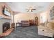 Cozy living room featuring a brick fireplace, ceiling fan and hardwood-style flooring at 105 Easy St, Mooresville, NC 28117