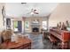 Spacious living room boasts a fireplace, ceiling fan, and comfortable seating with large windows at 105 Easy St, Mooresville, NC 28117