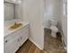 Functional half bathroom featuring a vanity with sink and a toilet, perfect for guests' convenience at 105 Southfork Ln, Belmont, NC 28012
