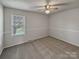 A clean and simple empty bedroom featuring neutral walls and carpet at 105 Southfork Ln, Belmont, NC 28012