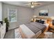 Cozy staged bedroom with a comfortable bed, soft lighting, and a view of the outdoors at 105 Southfork Ln, Belmont, NC 28012