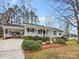Charming single-story home featuring a cozy porch, well-maintained landscaping, and a convenient carport at 105 Southfork Ln, Belmont, NC 28012