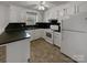 Bright kitchen features white cabinetry, dark countertops, modern appliances, and a window for natural light at 105 Southfork Ln, Belmont, NC 28012