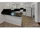 Traditional white kitchen featuring a black countertop and ample cabinet space at 105 Southfork Ln, Belmont, NC 28012