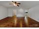 Bright living room featuring hardwood floors, a ceiling fan, and white walls, creating a cozy atmosphere at 105 Southfork Ln, Belmont, NC 28012