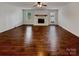Spacious living room with hardwood floors, a fireplace, and natural light at 105 Southfork Ln, Belmont, NC 28012