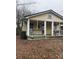 Quaint exterior featuring a porch with white railings and posts on a yellow home surrounded by bare trees at 1140 Mt Vernon Rd, Woodleaf, NC 27054