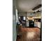 Kitchen view of the laminate flooring, white cabinets and black appliances adjacent to the living room at 1140 Mt Vernon Rd, Woodleaf, NC 27054