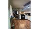 Charming kitchen view of the laminate flooring, white cabinets and black appliances adjacent to the living room at 1140 Mt Vernon Rd, Woodleaf, NC 27054