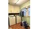 Compact laundry room features appliances, built-in storage, and natural light at 1140 Mt Vernon Rd, Woodleaf, NC 27054