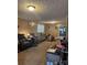 The living room is a cozy space with carpeting and wood paneled walls, with a view of the kitchen at 1140 Mt Vernon Rd, Woodleaf, NC 27054