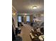 The spacious living room has carpeting and wood paneled walls, with a glimpse of the front entrance at 1140 Mt Vernon Rd, Woodleaf, NC 27054