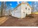 Backyard with a mix of grass and dirt, bordered by trees providing privacy and a shed at 1203 Northwoods Dr, Kings Mountain, NC 28086