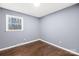 Bright bedroom featuring hardwood floors, a window with natural light, and gray painted walls at 1203 Northwoods Dr, Kings Mountain, NC 28086