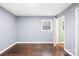 Bedroom featuring hardwood floors, a window with natural light, freshly painted gray walls and trim at 1203 Northwoods Dr, Kings Mountain, NC 28086