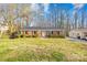 Traditional brick home with red shutters, showcasing a neat front yard and mature trees at 1203 Northwoods Dr, Kings Mountain, NC 28086