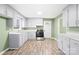 Bright kitchen featuring gray cabinets, stainless steel appliances, and a durable laminate floor at 1203 Northwoods Dr, Kings Mountain, NC 28086