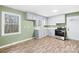 Cozy kitchen with gray cabinetry, modern appliances, and natural light from a large window at 1203 Northwoods Dr, Kings Mountain, NC 28086