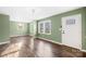 Bright living room with hardwood flooring, soft green walls, and a welcoming front entrance at 1203 Northwoods Dr, Kings Mountain, NC 28086