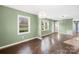 Well-lit living room featuring hardwood floors, soft green walls, and ample natural light at 1203 Northwoods Dr, Kings Mountain, NC 28086