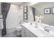 Well-lit bathroom featuring a double sink vanity, bathtub-shower combo, and tasteful decorations for a modern look at 1240 Cottage Green Dr # 0132, Monroe, NC 28112