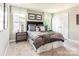Stylishly appointed bedroom with neutral tones, carpeted floors, and an abundance of natural light from large windows at 1240 Cottage Green Dr # 0132, Monroe, NC 28112