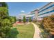 Exterior view of Atrium Health building with landscaped walkway and blue sky at 1240 Cottage Green Dr # 0132, Monroe, NC 28112
