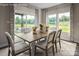 Elegant dining room with large windows, stylish curtains, and a light wood table at 1240 Cottage Green Dr # 0132, Monroe, NC 28112