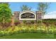 Community entrance sign beautifully landscaped with seasonal flowers and lush greenery for a welcoming curb appeal at 1240 Cottage Green Dr # 0132, Monroe, NC 28112