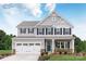 Charming two-story home with gray siding, white trim, black shutters and a two-car garage at 1240 Cottage Green Dr # 0132, Monroe, NC 28112