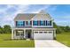 Charming two-story home with a two-car garage, landscaped yard, and inviting front porch at 1240 Cottage Green Dr # 0132, Monroe, NC 28112