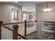 Upstairs hallway leading to a cozy living space with stylish decor and comfortable seating at 1240 Cottage Green Dr # 0132, Monroe, NC 28112