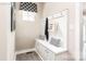 Practical mudroom area with a built-in bench, storage cabinets, hooks, and coordinated decor for organized living at 1240 Cottage Green Dr # 0132, Monroe, NC 28112