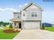 Charming two-story home with a two-car garage, manicured lawn, and inviting front porch at 13112 Hampton Bay Ln, Charlotte, NC 28262