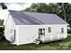 Back view of a charming home with a metal roof, and a deck, nestled in a green, grassy yard at 1473 32Nd Sw St, Hickory, NC 28602