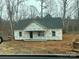 Unfinished exterior of single story home with dark grey roof, porch, and yard under construction at 1475 32Nd Sw St, Hickory, NC 28602