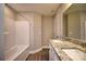 Well-lit bathroom featuring double sinks with granite countertop and a shower-tub combination at 1479 Southwest Blvd, Newton, NC 28658