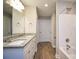 Bright bathroom with double granite sinks, white cabinets, and a shower/tub combination at 1479 Southwest Blvd, Newton, NC 28658