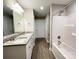Bathroom features a double vanity, vinyl flooring, and shower-tub combo at 1479 Southwest Blvd, Newton, NC 28658