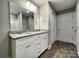 This bathroom features a double vanity with granite countertop and plank flooring at 1479 Southwest Blvd, Newton, NC 28658