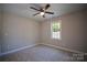 Bright bedroom featuring carpet, a ceiling fan, and a window providing natural light at 1479 Southwest Blvd, Newton, NC 28658