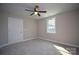 A serene bedroom featuring plush carpeting, a ceiling fan, and a bright window at 1479 Southwest Blvd, Newton, NC 28658