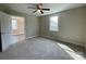 Bedroom with ceiling fan and bright window with an open door to another room at 1479 Southwest Blvd, Newton, NC 28658