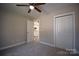A bedroom with carpeted flooring, a ceiling fan, closet, and a window at 1479 Southwest Blvd, Newton, NC 28658