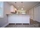 Kitchen featuring white cabinets, granite countertops, and modern pendant lighting at 1479 Southwest Blvd, Newton, NC 28658