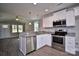 Modern kitchen with stainless steel appliances and granite countertops overlooking living area at 1479 Southwest Blvd, Newton, NC 28658